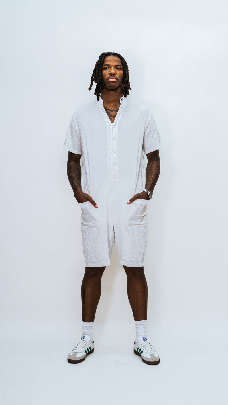 A model wearing the Milkwhite jumpsuit button down slightly opened and facing forward.