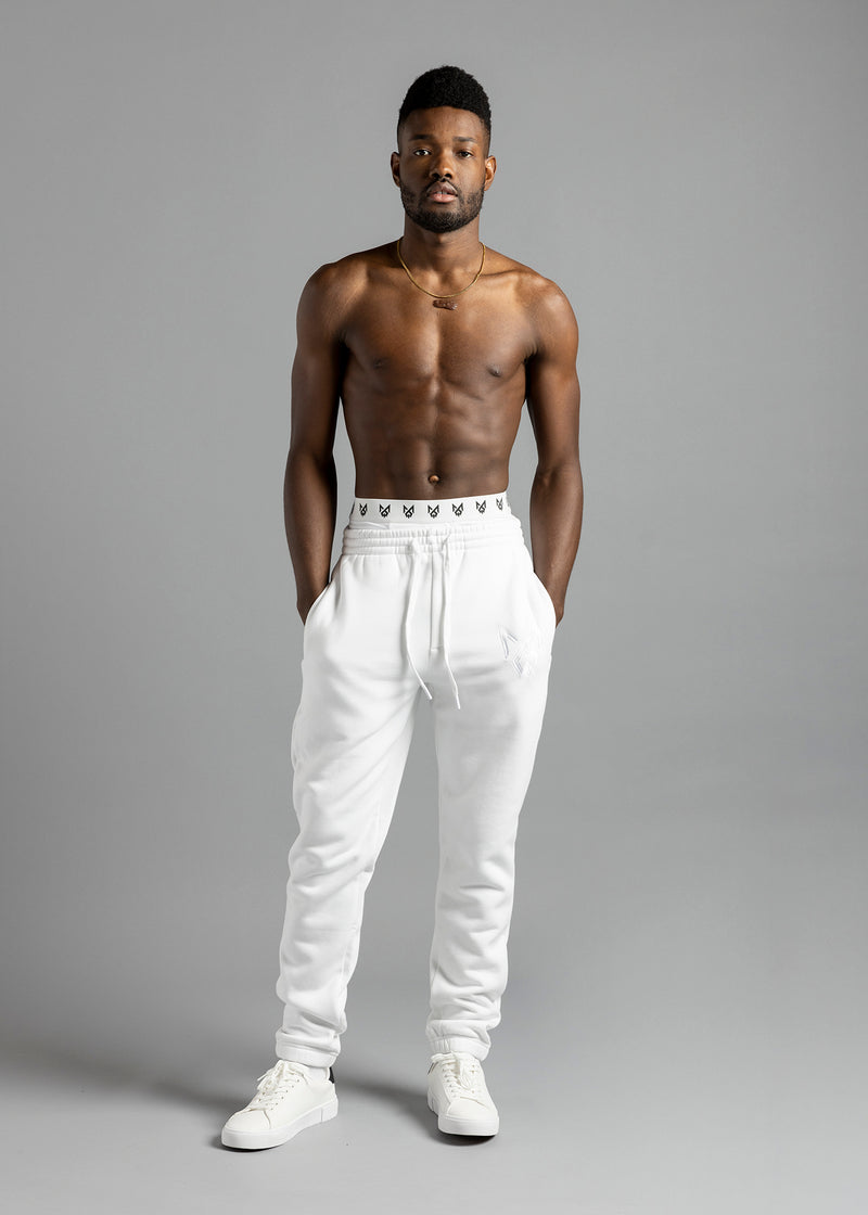 Full-length front view of a model wearing white MilkWhite Comfortable Joggers with hands in the side pockets and the drawstring waist visible.