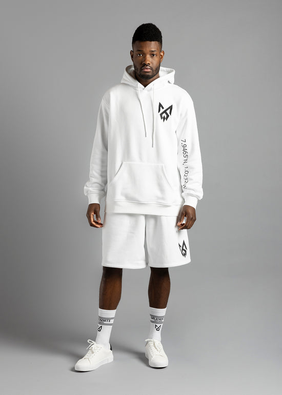 Model wearing an everyday premium MilkWhite white essential hoodie with sleeve ghana coordinate details and MW logo.