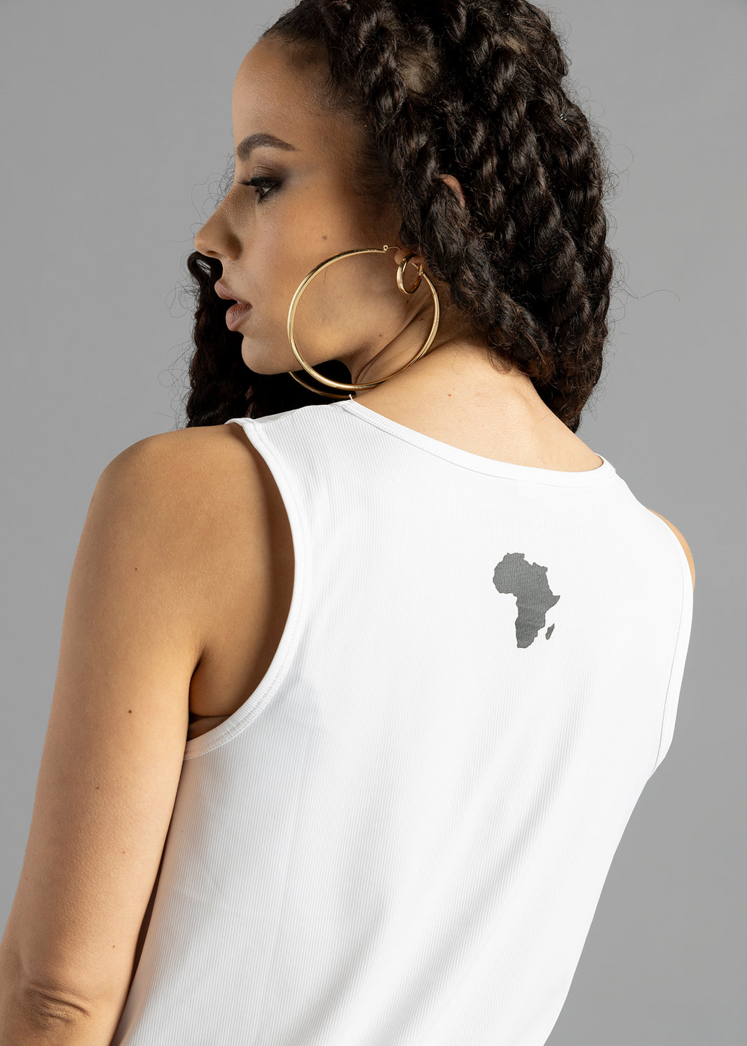 Rear three-quarter view of the white MilkWhite Premium Tank Top, showing the rounded back neckline and Africa-shaped graphic.