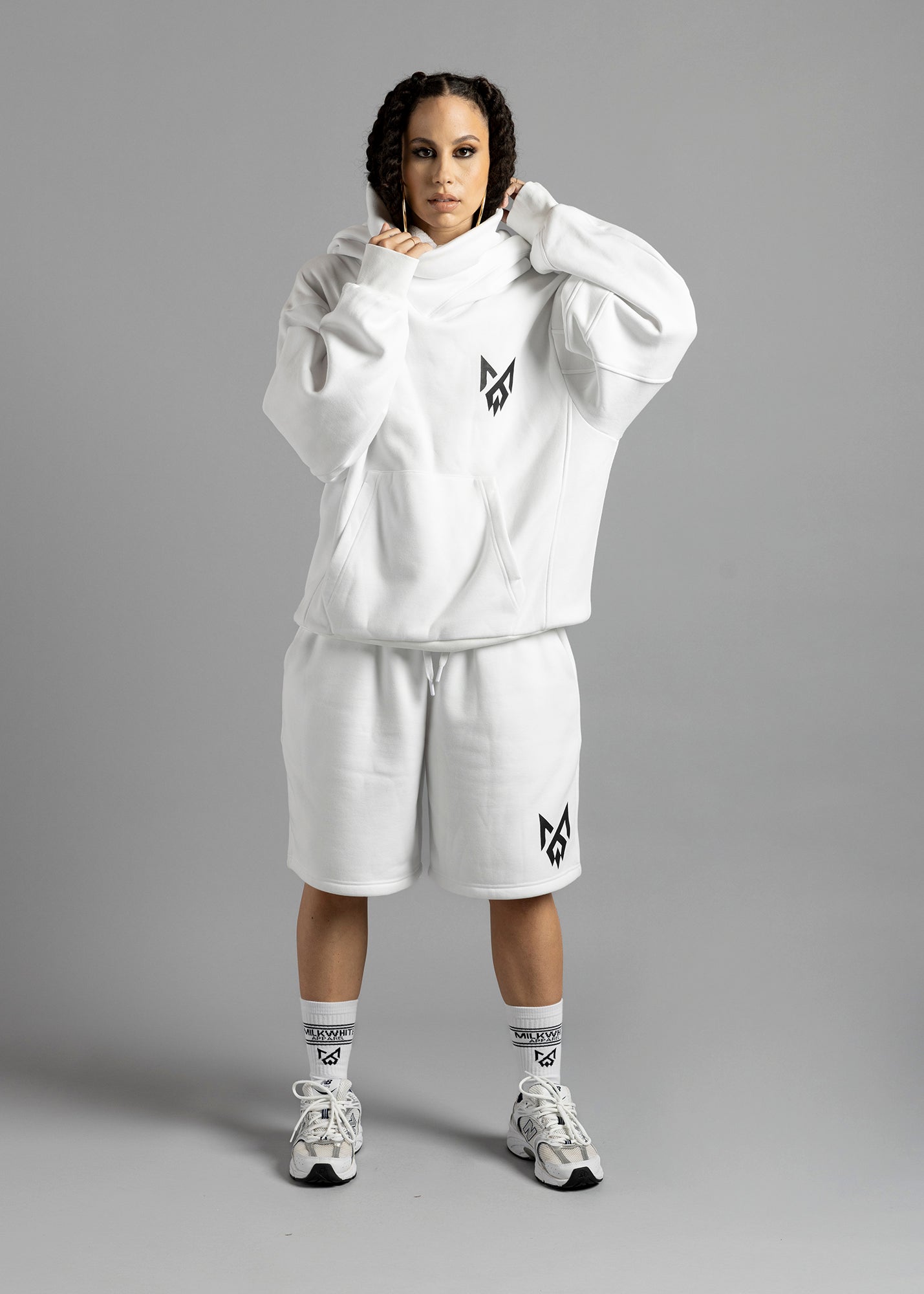 Model wearing signature white Rosebud hoodie with turtleneck hood and the Milkwhite Apparel logo on the left breast, paired with MilkWhite white shorts and MW Socks