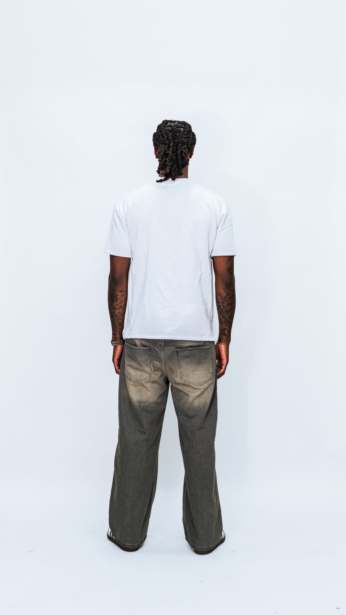 Full-length rear view of a model wearing the white MilkWhite Short Sleeve Sweatshirt, showing its plain back and short sleeves.