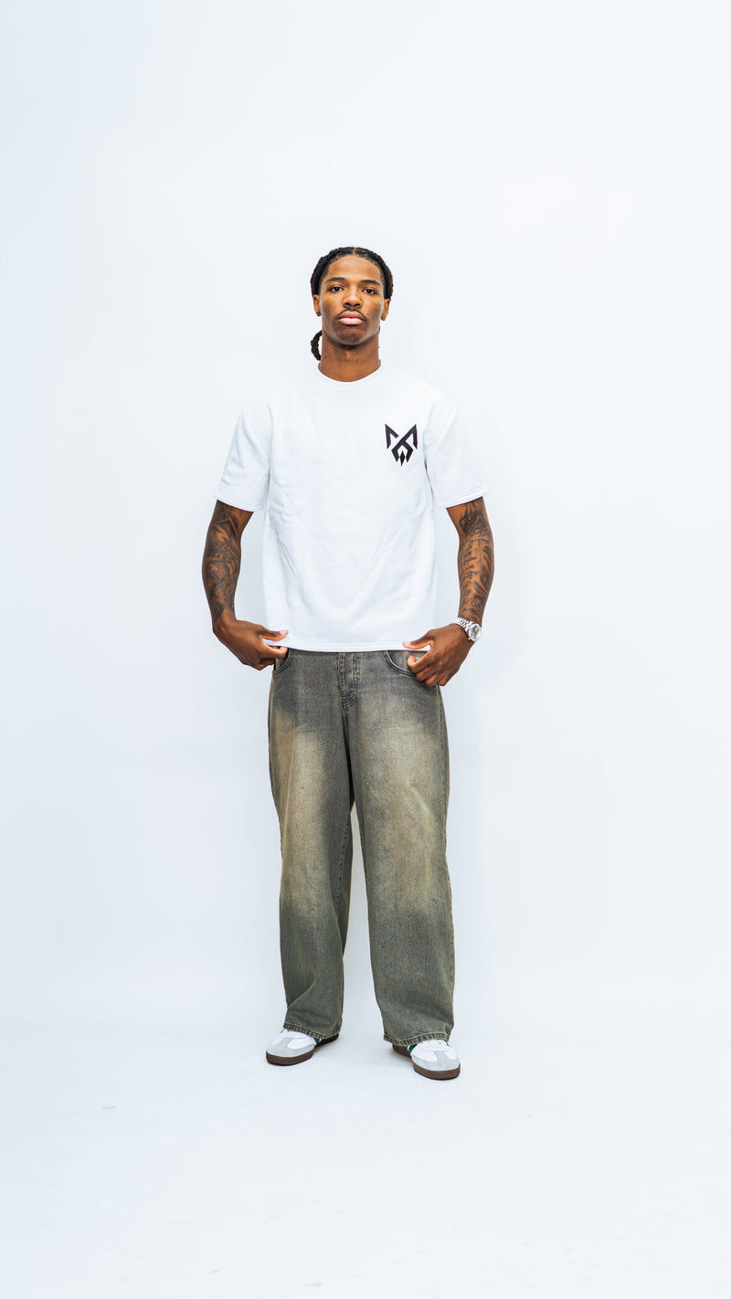 Full-length front view of a model wearing the white MilkWhite Short Sleeve Sweatshirt, showing its crew neck and black chest logo.