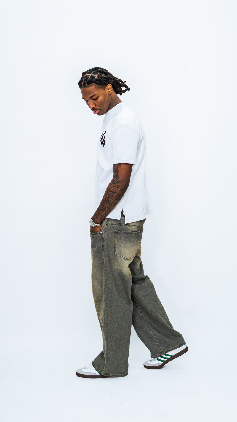 Side view of a model wearing the white MilkWhite Short Sleeve Sweatshirt, showing the short sleeve and slit at the side hem.