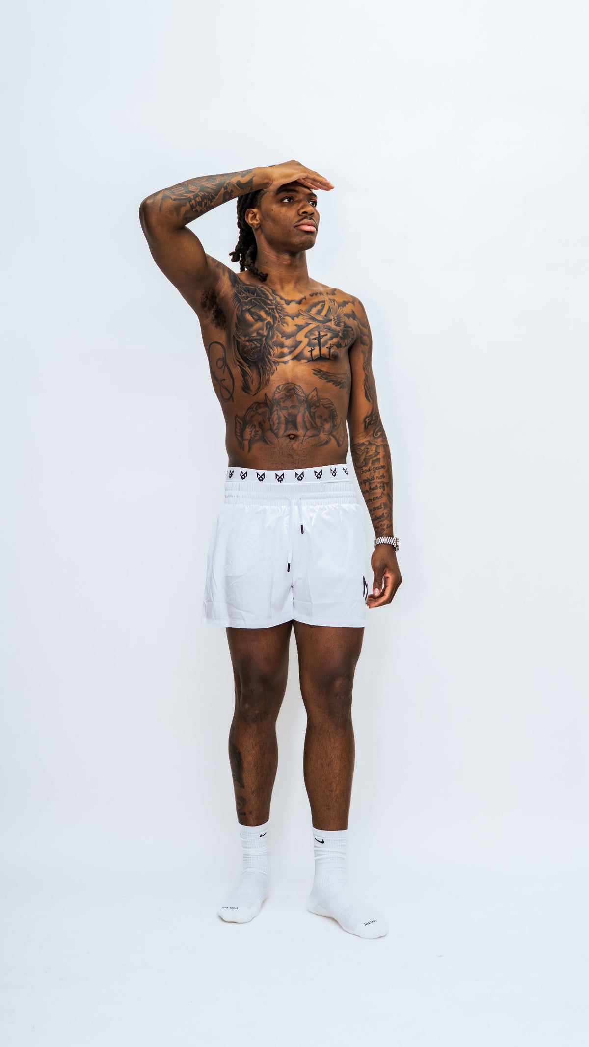 Model wearing Milkwhite Short swim trunks casually against a white background.