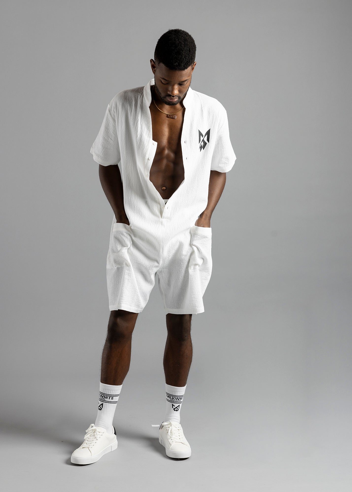 Model wearing textured white cotton button-up jumpsuit