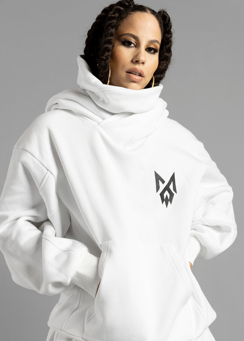 Front view of a model wearing the white Rosebud Hoodie by MilkWhite with both hands in the kangaroo pocket.