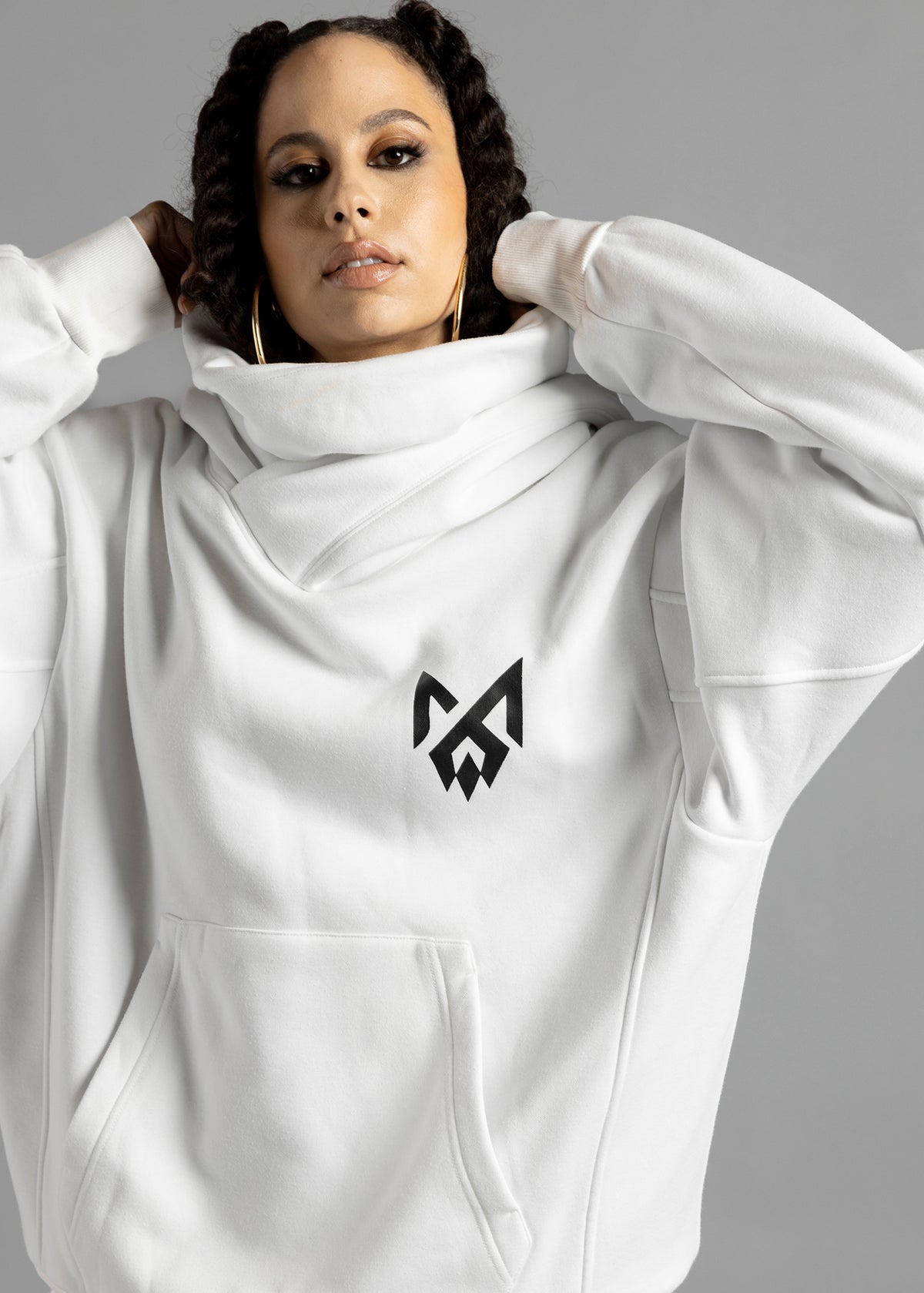 Front close-up of the white Rosebud Hoodie by MilkWhite, showing the draped neckline, black chest logo and kangaroo pocket.